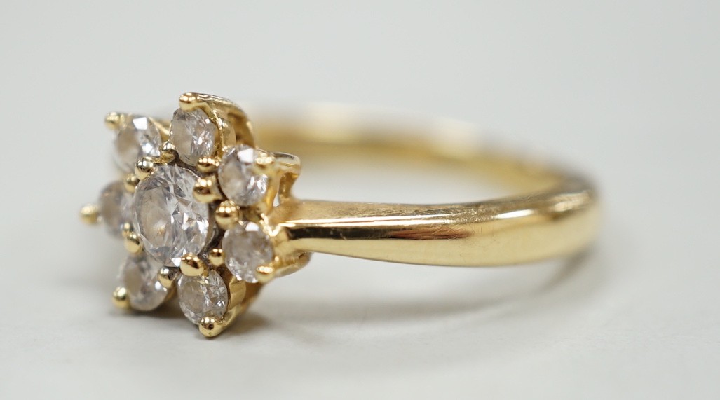 A modern yellow metal and diamond set flower head cluster ring, size L, gross weight 2.9 grams.